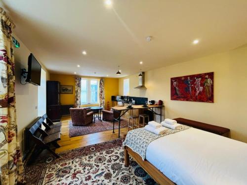 a bedroom with a bed and a desk in a room at Black Isle Bar Apartment in Fort William