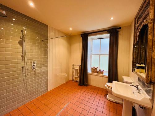 a bathroom with a shower and a toilet and a sink at Black Isle Bar Apartment in Fort William