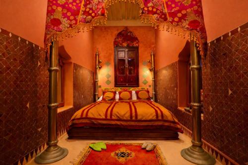 a bedroom with a bed and a large mirror at Riad Rafeef in Essaouira