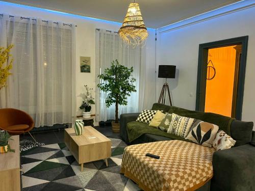 a living room with a couch and a table at La Dryade in Braux