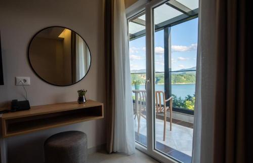 a mirror in a room with a view of a balcony at Hotel Leon in Debar