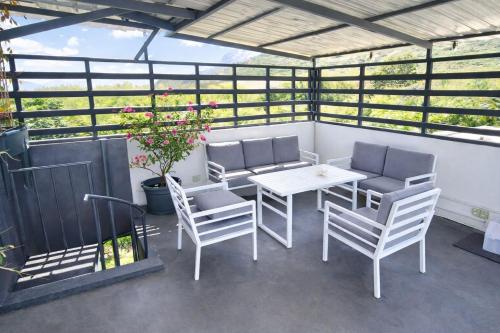 a patio with a table and chairs in a building at RayGrass, La Gaulette in La Gaulette