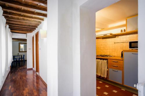 a kitchen with white walls and wooden floors at Drago D'oro Boutique Apartment in Florence