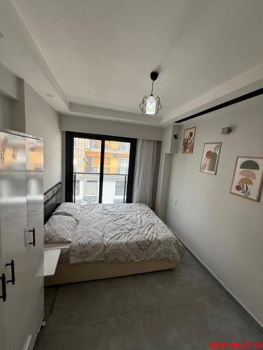 a bedroom with a large bed and a window at Erdem Apart D4 in Dalaman