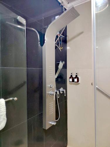 a shower with a glass door in a bathroom at Fields Palace Hotel in Angeles