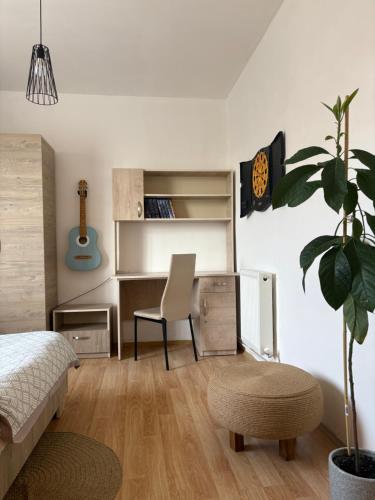 a bedroom with a bed and a desk and a chair at TREFOIL in Lori Berd