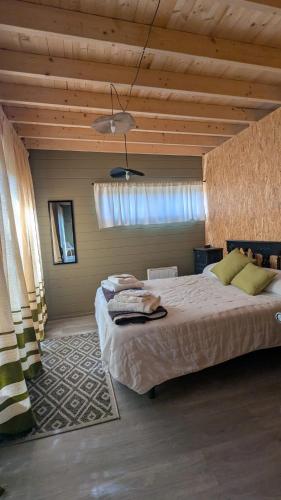 a bedroom with a large bed and a wooden ceiling at Finca Real in Negreira