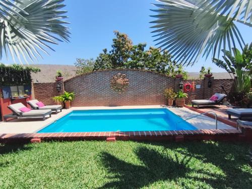 a swimming pool in the backyard of a house at Casa Punta Perula VILLAS in Pérula