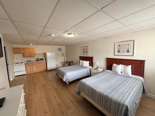 a hotel room with two beds and a kitchen at Seabreeze Motel in Old Orchard Beach