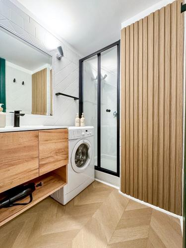 a bathroom with a washer and dryer in a room at Il Vicoletto Marino in Marino