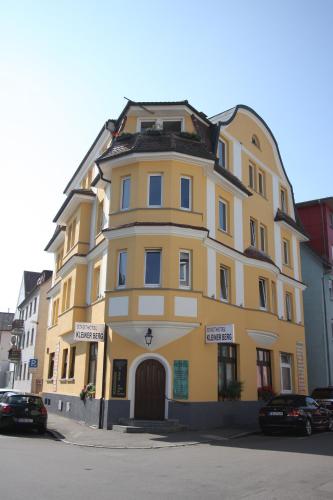 a yellow building on the side of a street at Stadthotel Kleiner Berg in Friedrichshafen