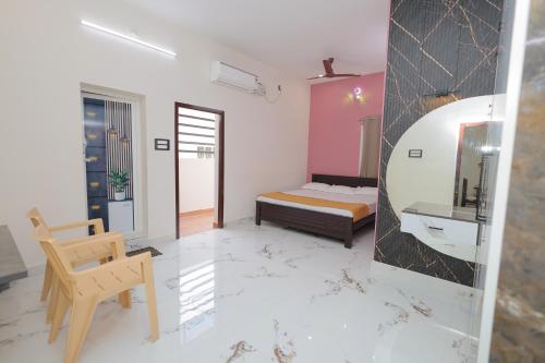 a bedroom with a bed and a sink and a mirror at MK service apartment in Tirunelveli