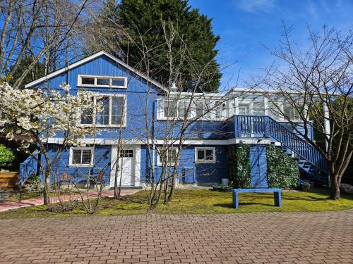 a blue house with a blue bench in front of it at 7811 The Solace Vista in Vancouver
