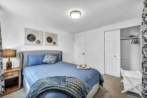 a bedroom with a blue bed and white walls at 113 Madison Ave, Cuyahoga Falls in Cuyahoga Falls