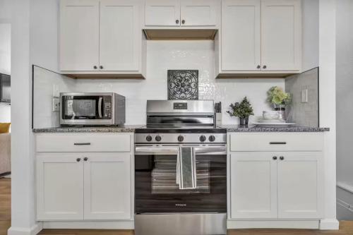 a white kitchen with a microwave and a stove at 113 Madison Ave, Cuyahoga Falls in Cuyahoga Falls