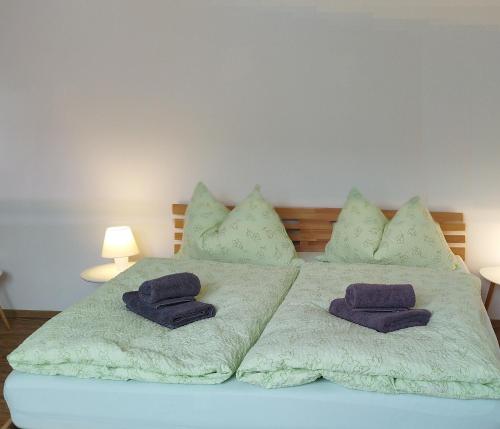 a bed with two pillows on top of it at Apartment Bertík in Třeboň
