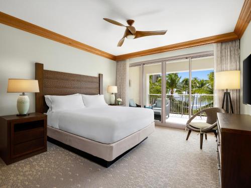 a bedroom with a white bed and a balcony at Hyatt Vacation Club at Ka'anapali Beach in Lahaina
