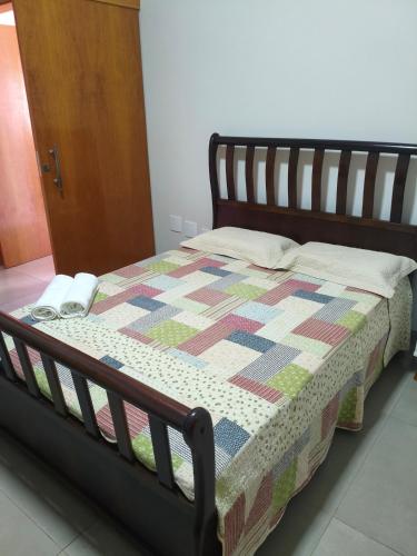 a bed with a quilt on it in a room at Recanto Três Rios in Santa Clara dʼOeste