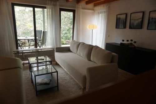 a living room with a white couch and a table at Ferienwohnung EGS in Lahr