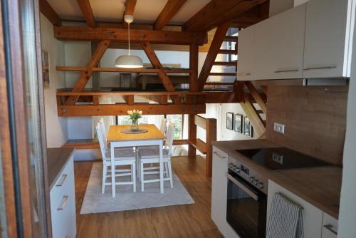 a kitchen with a table in a tiny house at Ferienwohnung EGS in Lahr