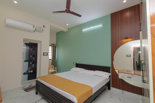 a bedroom with a bed and a mirror at MK service apartment in Tirunelveli