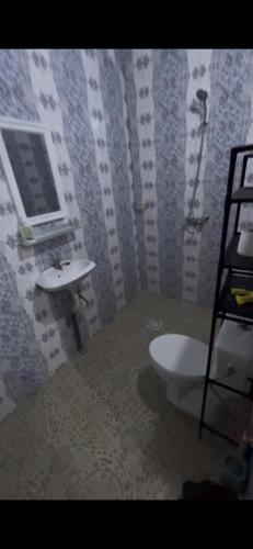 a bathroom with a sink and a toilet at Résidence Eden2 in San-Pédro