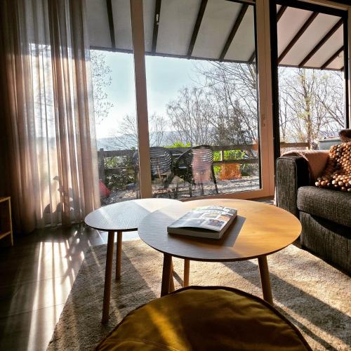 a living room with a couch and a table at Slow Stay Coo in Stavelot