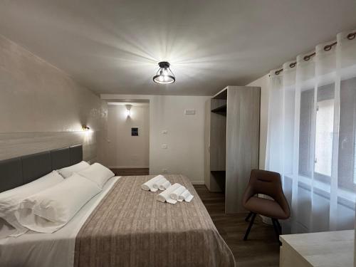 a bedroom with a bed with two towels on it at I due archi in Norcia