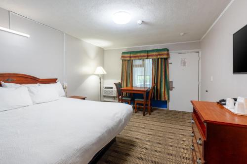 a hotel room with a bed and a desk at Attleboro Motor Inn in South Attleboro