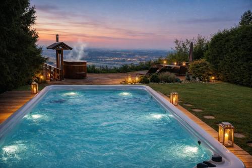 a swimming pool in the middle of a yard at Panoramic View Cottage House - Private Wellness Retreat in Hočko Pohorje