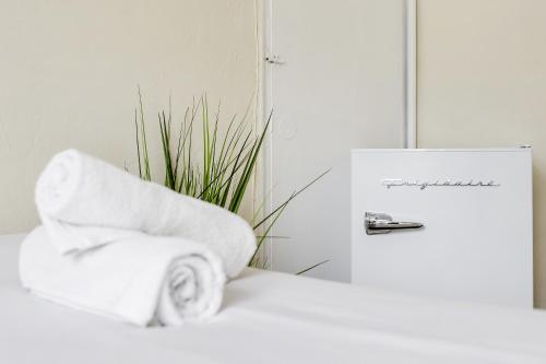 a stack of towels sitting next to a plant at Starlite Hotel in Miami Beach