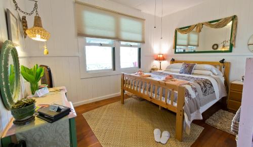 a bedroom with a bed and a mirror at Hale Kawehi B&B Guesthouse in Hilo