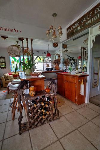 a kitchen with a counter and a table with wine bottles at Hale Kawehi BnB Guesthouse in Hilo