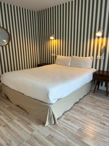 a large bed in a room with at Hotel Eden in Saint Malo