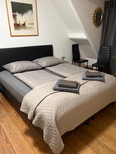 a bedroom with a bed with two pillows on it at La Casa aan Zee in Ellemeet