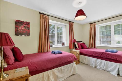 two beds in a room with windows at 3 Bed in Braunton oc-ashb in Braunton
