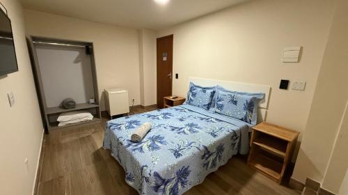a bedroom with a bed with a phone on it at Caminho de Itacoatiara in Niterói
