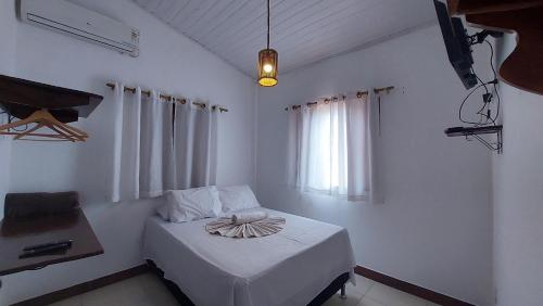 a bedroom with a bed with a bowl on it at Pousada Casa de Jorge 2 in Lençóis