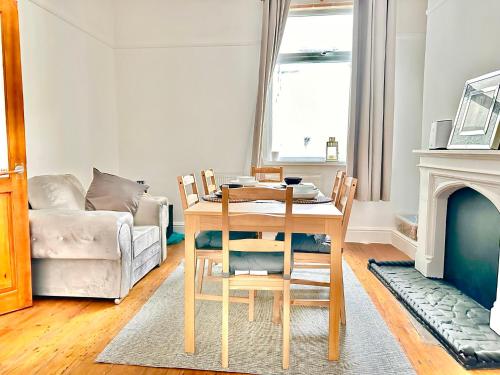a living room with a table and a couch at New Brighton Beach in Wallasey