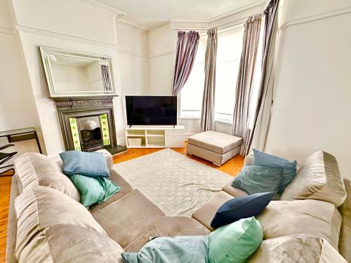 a living room with a couch and a fireplace at New Brighton Beach in Wallasey