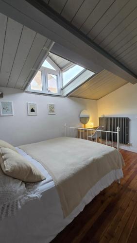 a bedroom with a large bed with a skylight at Fontana Maggiore View Suite in Perugia