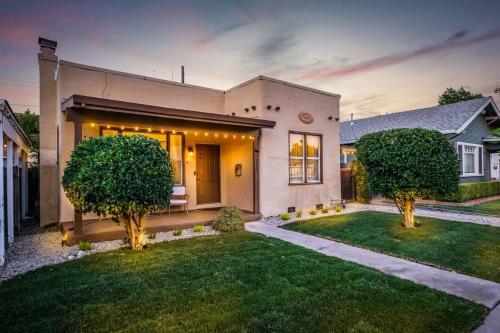 a house with two trees in the front yard at Unique Bungalow w/ hot Spa in DT in Sacramento