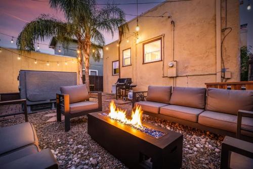 a living room with a couch and a fire pit at Unique Bungalow w/ hot Spa in DT in Sacramento