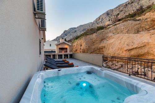 a hot tub on the balcony of a building at Mimice Hills Luxury Penthouse 229 m2, Panoramic Wrap Terrace, Jacuzzi,BBQ in Mimice