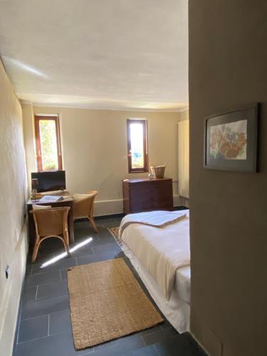 a bedroom with a bed and a desk and a chair at New IL RICCIO in Cernobbio