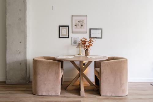 a dining room with a table and two chairs at The Slate Luxury Capitol View DOCO Golden 1 in Sacramento