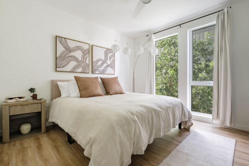 a white bedroom with a large bed and a window at The Eyrie Group Fun Luxury DT Events Corporate in Sacramento