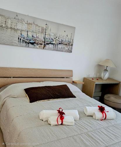 a bedroom with a bed with towels on it at Le Caravelle in Mestre