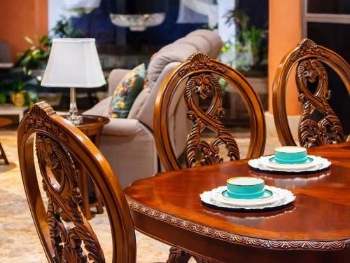 a wooden table and chairs with bowls on top of it at Solanza Club & Residence in Cancún