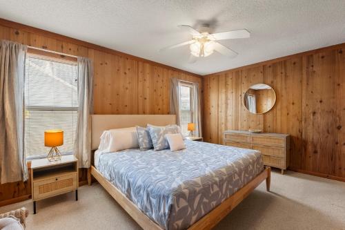 a bedroom with a bed and a ceiling fan at Happy Ours in Corolla